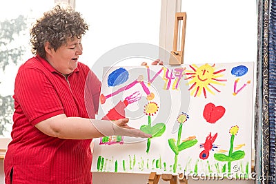 Mentally disabled woman showing her painting Stock Photo