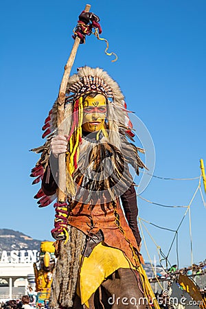 Menton, France-February 12, 2023: Unidentified woman dressed colorful carnival costume red indian. Editorial Stock Photo