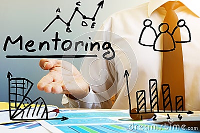 Mentoring concept. Mentor at the table in the office. Stock Photo