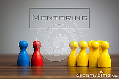 Mentoring concept with pawn figurines on table Stock Photo