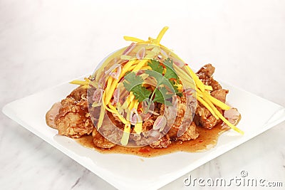 the menu of a restaurant called Mango Chicken. Flour fried chicken with spices and mango Stock Photo