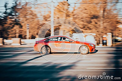 Mercedes E-Class C238 coupe on the city road. Fast moving shiny red car on Moscow streets. Premium Mercedes-Benz E 300 Sport side Editorial Stock Photo