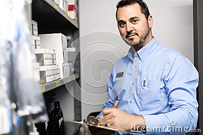 Merchandiser checking products availibility for car repair Stock Photo