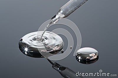 Mercury pouring from a pipette. Stock Photo