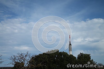 Mercury Redstone rocket pointing above trees towards sky Stock Photo