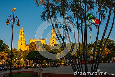 Merida San Ildefonso cathedral in the evening. Mexican flag flutters on air. Yucatan. Mexico Editorial Stock Photo