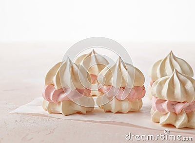 Meringue cakes on pink background Stock Photo