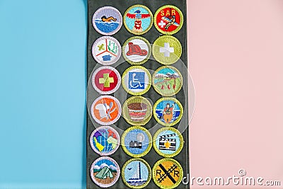 Merit Badge Sash on Blue and Pink Editorial Stock Photo