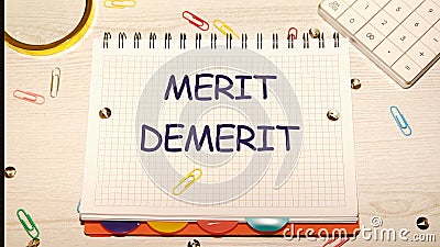 Merit, demerit and its retributions at the level of the individual. MERIT DEMERIT words in a notebook on the table Stock Photo