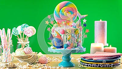 Mermaid theme candyland cake with glitter tails, shells and sea creatures. Stock Photo