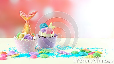 Mermaid theme cupcakes with colorful glitter tails, shells and sea creatures. Stock Photo