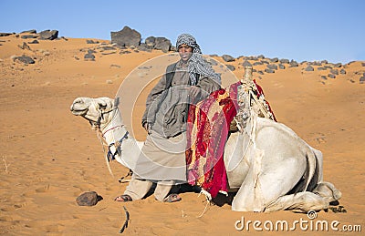 Sudanese young man with his camel in a desert Editorial Stock Photo