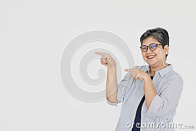 Merry Asian woman pointing away Stock Photo