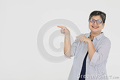 Merry Asian woman pointing away Stock Photo