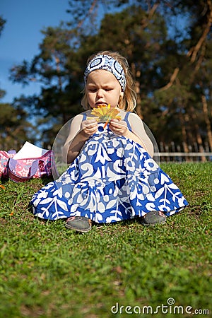 Merry beautiful girl sitting on green grass Stock Photo