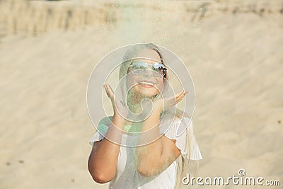 Merry blonde model wearing glasses posing with exploding green H Stock Photo