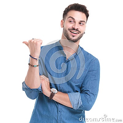 Merry casual man laughing and pointing to the side Stock Photo