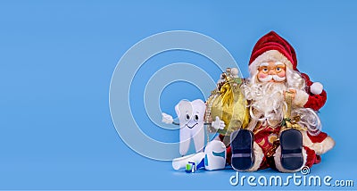 Merry Christmas From Dentist Tooth Model With Presents On Blue Background With Copy Space Stock Photo