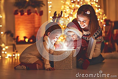 Merry Christmas! family mother and children with magic gift at Stock Photo