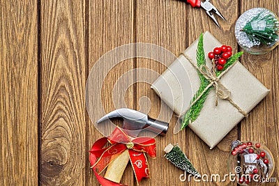 Merry Christmas Handy Tools Christmas Gift concept. Hammer, pliers, gift box and Christmas ornament decorations on wood Stock Photo