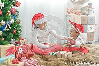 Merry Christmas and Happy Holidays! Cheerful 2 little girls playing and have fun together Stock Photo