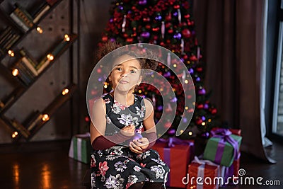 happy little child with gifts and Christmas tree and lights Stock Photo