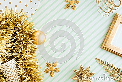 Merry christmas and happy new year background.top view of sparkling gold tinsel,ball,ornament decorate on green strip line table. Stock Photo