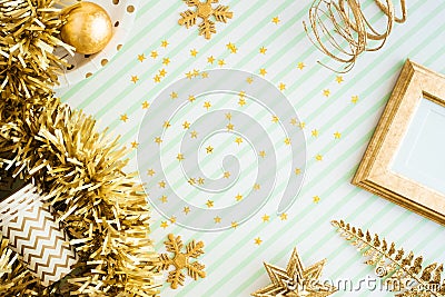 Merry christmas and happy new year background.top view of sparkling gold tinsel,ball,ornament decorate on green strip line table. Stock Photo
