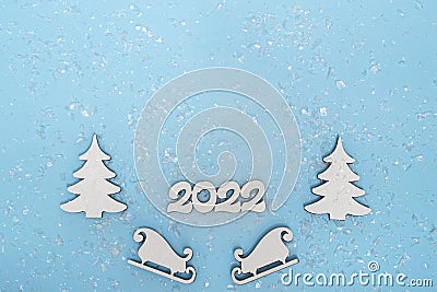 Merry Christmas and Happy New Year banner. Festive poster with a Christmas tree, sledges and snow on a blue background Stock Photo