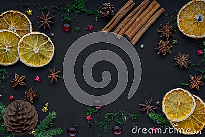 Merry Christmas and happy new year. composition on a black background of Christmas tree branches, cones, toys, cinnamon Stock Photo