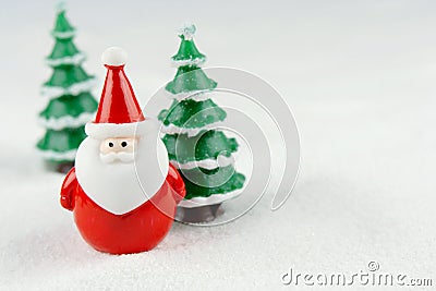 Merry Christmas and happy new year concept. Cute santa claus figure and tree on snow with copy space Stock Photo