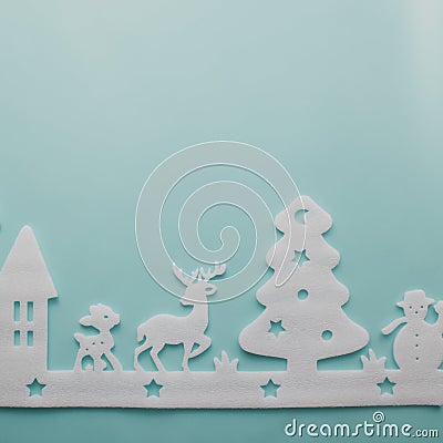 Merry Christmas and Happy New Year. Foam cutter of City with reindeers and snow boy, art and craft style on pastel color paper Stock Photo