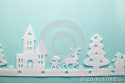 Merry Christmas and Happy New Year. Foam cutter of City with reindeers and snow boy, art and craft style on pastel color paper Stock Photo