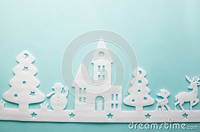 Merry Christmas and Happy New Year. Foam cutter of City with reindeers and snow boy, art and craft style on pastel color paper Stock Photo