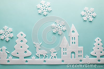 Merry Christmas and Happy New Year. Foam cutter of City with snowflake, art and craft style on pastel color paper Stock Photo