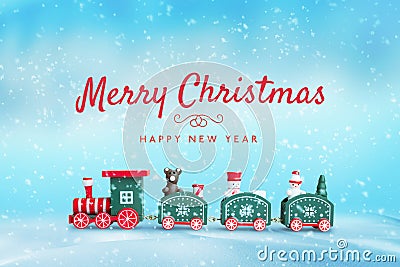 Merry Christmas and Happy New Year greeting card with cute wooden train toy in snow Stock Photo
