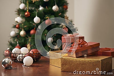 Merry Christmas and Happy New year Holidays! Decorating the Christmas tree indoors. Macro or close picture of xmas tree and gifts Stock Photo