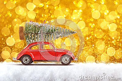 Merry Christmas and Happy New Year Postcard or Poster. Little classic red car carrying Christmas tree on its rack on the Stock Photo