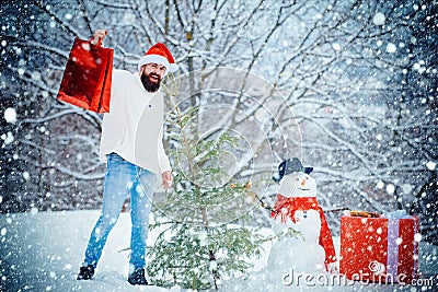 Merry Christmas and Happy new year. Christmas shop or store. Winter emotion. Snowman and funny bearded man with gift - Stock Photo