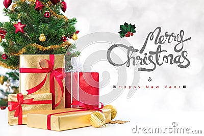 Merry Christmas and Happy New Year text with gift boxes and ornaments Stock Photo
