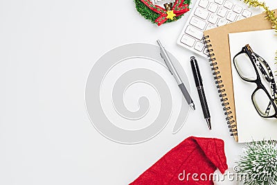 Merry Christmas and Happy new years office work space desktop concept. Flat lay top view with keyboard, red hat, glasses and Stock Photo