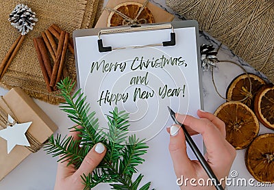 Merry Christmas and Hippy New Year Inspiration joke quote phrase Woman making Box with New Year& x27;s gifts, wrapped in Stock Photo