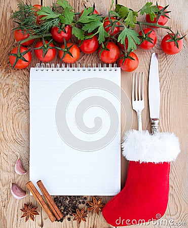 Merry Christmas menu card.Tomatoes, garlic, parsley and spices on the wooden background with space for text. Stock Photo