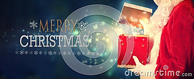 Merry Christmas message with Santa opening a gift box Stock Photo