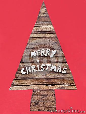 Merry Christmas message with wooden letters and a stylized Christmas tree Stock Photo