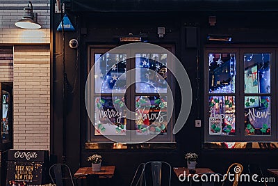 Merry Christmas sign on the window of O`Neills pub in Soho, London, UK Editorial Stock Photo