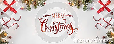 Merry Christmas Typographical on white background with gift boxes, fir branches, red decoration. Stock Photo