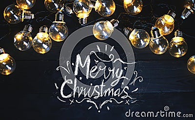 Merry Christmas Typography Light Bulbs on Black Wood Stock Photo