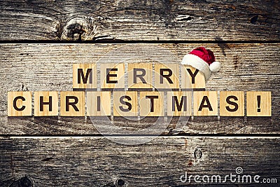 Merry Christmas. Words made up of alphabet on wooden cubes. Wooden background. Christmas background. Stock Photo