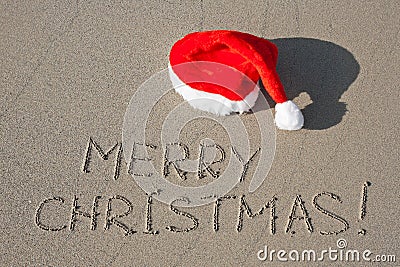 Merry Christmas written on sand Stock Photo